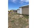 Exterior view of a white shed showing a building construction site in the distance at 15200 Holly St, Thornton, CO 80602