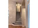Staircase with modern railing and neutral wall paint at 6973 Summerset Ave, Longmont, CO 80504