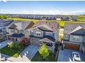 Expansive aerial view of a two-story home in a neighborhood with open fields nearby at 15608 E Otero Cir, Centennial, CO 80112