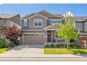 Charming two-story home with a two-car garage and a well-manicured lawn at 15608 E Otero Cir, Centennial, CO 80112