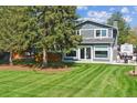 Expansive backyard featuring a wooden deck and a lush, green lawn perfect for outdoor activities and relaxation at 6537 S Brentwood Way, Littleton, CO 80123