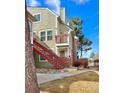 The exterior shows a stairway to the condo above and a balcony area with view of the neighborhood at 912 S Dearborn Way # 3, Aurora, CO 80012