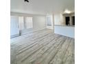 Spacious living area featuring durable gray wood floors and light-filled windows that add to the appeal of the home at 912 S Dearborn Way # 3, Aurora, CO 80012