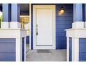 Close-up of the front door with stylish hardware and a charming light fixture, inviting guests inside at 16840 Hoot Owl Ct, Parker, CO 80134