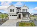 Charming two-story home featuring a spacious two-car garage, inviting front porch, and professionally landscaped front yard at 7137 S Vandriver Way, Aurora, CO 80016