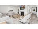 Bright and inviting living room with fireplace, plush sofa, stylish chairs, and large TV for relaxation at 7137 S Vandriver Way, Aurora, CO 80016