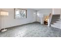 Bright living room featuring tile floors, staircase, and lots of natural light at 11121 W 107Th Pl, Westminster, CO 80021