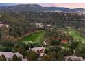 Scenic aerial view of a home surrounded by lush greenery and a golf course in the distance at 786 International Isle Dr, Castle Rock, CO 80108