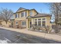 Charming two-story house with a combination of stone and siding, complemented by winter landscaping at 4396 S Quail Way, Littleton, CO 80127