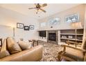 Cozy living room featuring a fireplace, built-in shelving, and comfortable seating at 4396 S Quail Way, Littleton, CO 80127