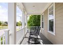 Welcoming front porch with rocking chairs, perfect for relaxing and enjoying the neighborhood views at 6072 Chester St, Denver, CO 80238