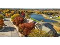 Stunning aerial view of neighborhood homes with lush trees and a tranquil lake at 3337 W 113Th Ave, Westminster, CO 80031