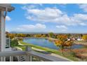 Picturesque view of a serene lake surrounded by colorful trees from the home's balcony at 3337 W 113Th Ave, Westminster, CO 80031