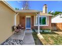 Inviting front porch with brick accents, stylish seating, and a blue entry door at 8483 Sandreed Cir, Parker, CO 80134