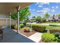 Inviting front porch featuring beautiful landscaping, manicured lawn, and views of the neighborhood at 7312 S Moore Ct, Littleton, CO 80127