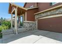 A close up of the front exterior with a view of the garage and entryway at 9919 Memphis St, Commerce City, CO 80022