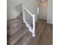 Interior staircase with white trim and black railing, leading to the upper level of the home at 2176 S Haleyville Way, Aurora, CO 80018