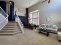 Spacious living room with soaring ceilings, large windows, neutral decor, and elegant furnishings at 5724 S Rome St, Aurora, CO 80015