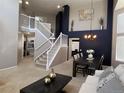 Open-concept living room with staircase, soaring ceilings, stylish decor and great natural light at 5724 S Rome St, Aurora, CO 80015
