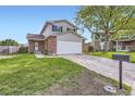 Inviting two-story home featuring a two-car garage and a lush green lawn at 9630 W 104Th Ave, Broomfield, CO 80021