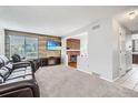 Inviting living room featuring a decorative fireplace, plush carpeting, and ample natural light at 9630 W 104Th Ave, Broomfield, CO 80021