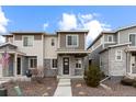 Charming two-story home with stone accents, a covered porch, and well-maintained landscaping at 23630 E 5Th Pl, Aurora, CO 80018