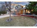 Charming home featuring a well-manicured lawn, mulched beds, and a cozy front porch at 7463 Soapstone Way, Castle Rock, CO 80108
