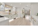 Bright kitchen features white cabinetry, modern countertops, and stainless steel appliances with gold hardware at 3281 Vivian Dr, Wheat Ridge, CO 80033