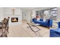 Inviting living room with fireplace, large windows, and a comfortable blue sofa at 3281 Vivian Dr, Wheat Ridge, CO 80033