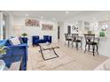 Bright living room with modern lighting, stylish furniture, open floor plan and access to the kitchen counter seating at 3281 Vivian Dr, Wheat Ridge, CO 80033