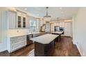 This spacious kitchen is highlighted by modern appliances, pendant lighting, and wood floors at 286 Warwick Pl, Castle Pines, CO 80108