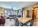 Inviting living room and dining area with a fireplace, ceiling fan, and wood accents at 505 S Main St # 1313, Breckenridge, CO 80424