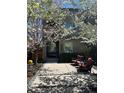 Two-story home featuring flowering trees, walkway and chairs at 2334 Lowell Blvd, Denver, CO 80211