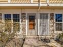 Inviting front entrance with stone accents, decorative door, and welcoming 'hello' mat at 1247 S Idalia St, Aurora, CO 80017