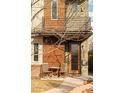 Front exterior featuring a stylish door, a balcony, a small seating area and artistic wooden slats at 4544 Utica St, Denver, CO 80212