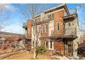 Charming townhome with brick and neutral panels, multiple balconies, and a cozy seating area near the entrance at 4544 Utica St, Denver, CO 80212