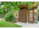 Stylish townhouse with an attractive wood-paneled front door and modern exterior lighting at 4544 Utica St, Denver, CO 80212