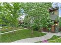 Multi-level townhouse with a well-manicured lawn, brick accents, and a welcoming walkway at 4544 Utica St, Denver, CO 80212