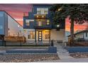 Beautiful modern home with a private balcony, professional landscaping, and cozy outdoor lighting at 1259 Perry St, Denver, CO 80204