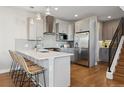 Sleek kitchen with stainless steel appliances, quartz countertops, and breakfast bar at 1259 Perry St, Denver, CO 80204