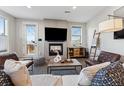 Cozy living room with fireplace, modern furnishings, mounted TV, and abundant natural light from the sliding glass door at 1259 Perry St, Denver, CO 80204
