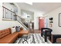 Open concept living area with modern decor, hardwood floors and a view to the kitchen at 11381 Jay St, Westminster, CO 80020