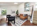 Bright living room with vaulted ceilings, wood floors, modern furnishings and staircase at 11381 Jay St, Westminster, CO 80020