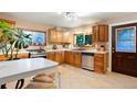 Charming kitchen featuring wood cabinets and updated stainless steel appliances at 4210 S Fox St, Englewood, CO 80110
