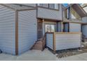 Charming entryway with a secure gate, wooden steps, and a cozy porch area at 8911 W Yale Ave, Lakewood, CO 80227