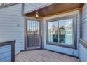 Quaint front porch featuring a secure door and ample natural light at 8911 W Yale Ave, Lakewood, CO 80227