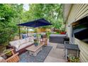 Inviting backyard patio with comfortable seating, an umbrella, grill and hot tub, perfect for outdoor gatherings at 8217 Club Crest Dr, Arvada, CO 80005
