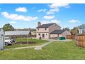 Spacious backyard with green lawn, large shed, and open carport at 1206 Baldwin Park Cir, Castle Rock, CO 80104