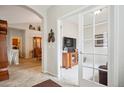 Welcoming foyer with tile flooring, archway, and doorway to a cozy living room showcasing neutral tones and natural light at 6617 S Reed Way # C, Littleton, CO 80123