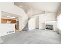 Bright, open-concept living area features high ceilings, a cozy fireplace, and seamless flow to the kitchen at 9691 Independence Dr, Westminster, CO 80021
